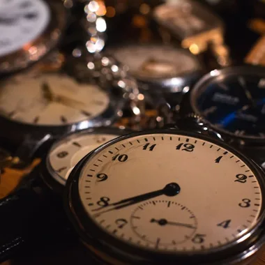 gold pocket watch on white surface